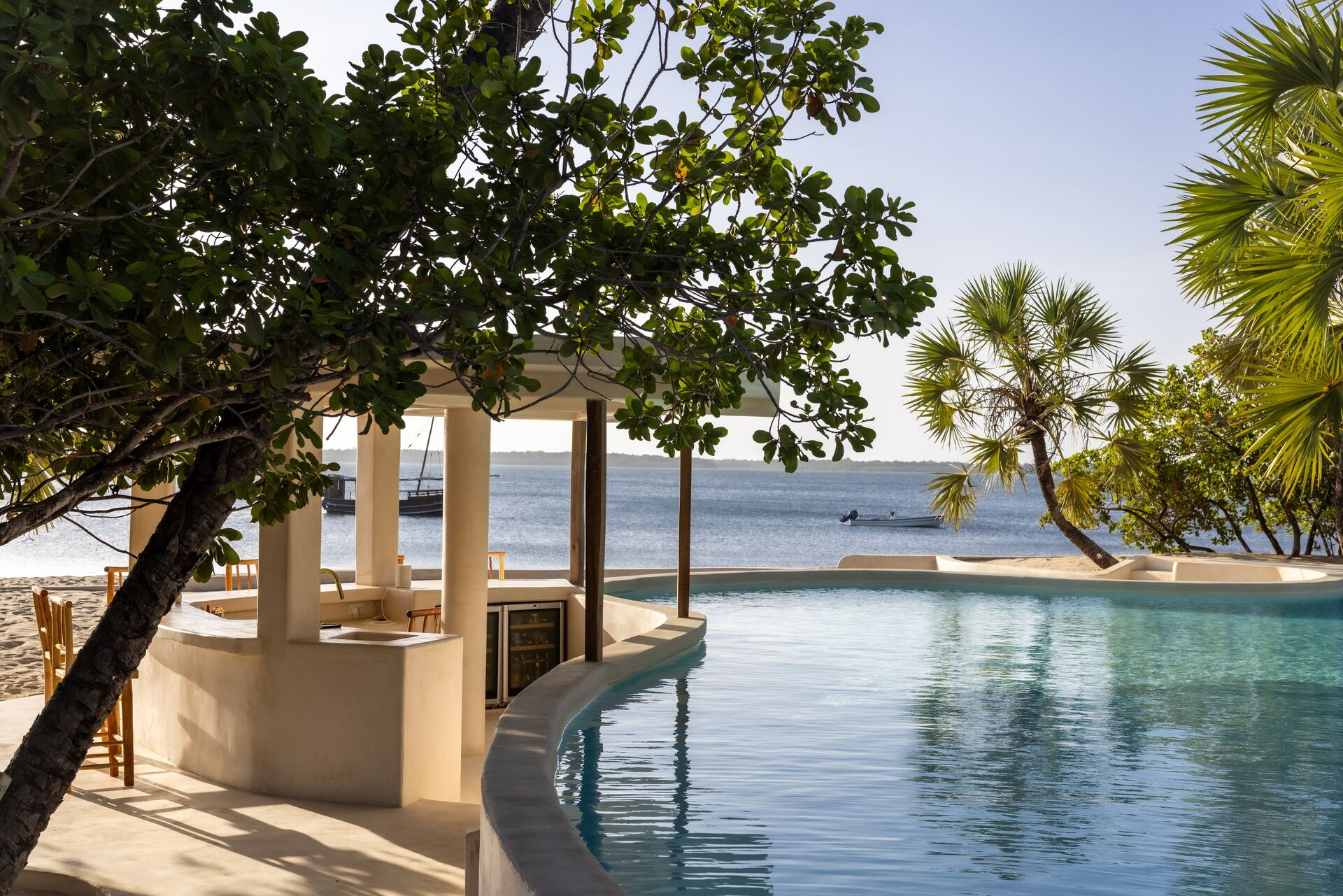 A quiet corner of The Cabanas — white linen, palms, the long view