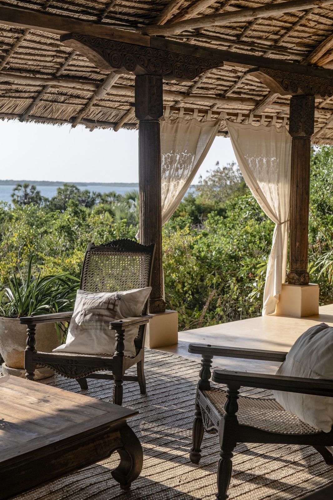 A woven mkeka palm mat underfoot in a cabana