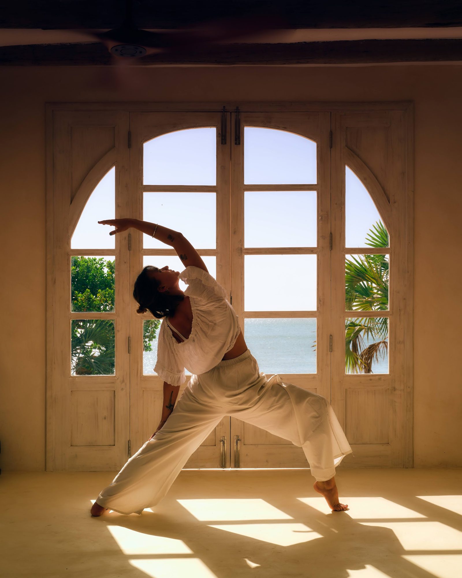 A morning yoga practice on the deck — quiet movement, ocean light
