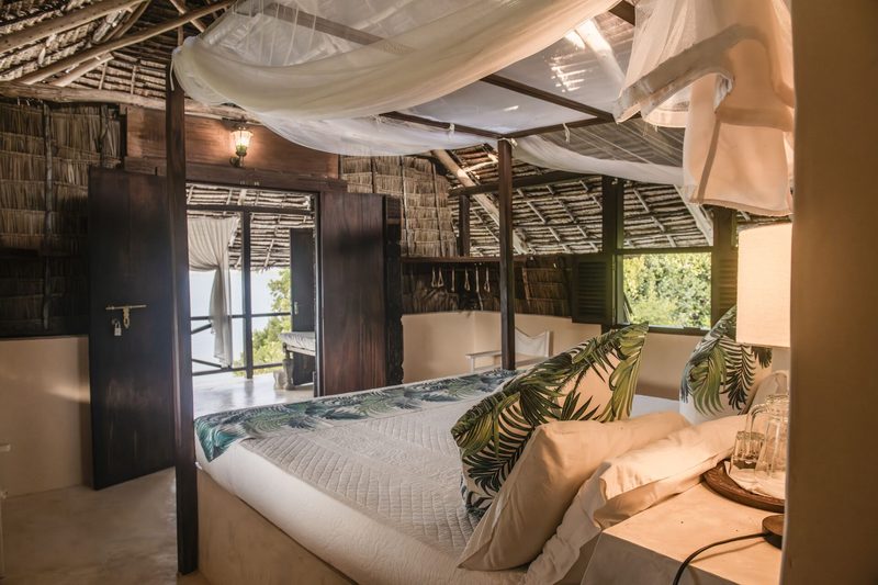 Makai cabana — view from a netted bed through an open terrace toward the Indian Ocean