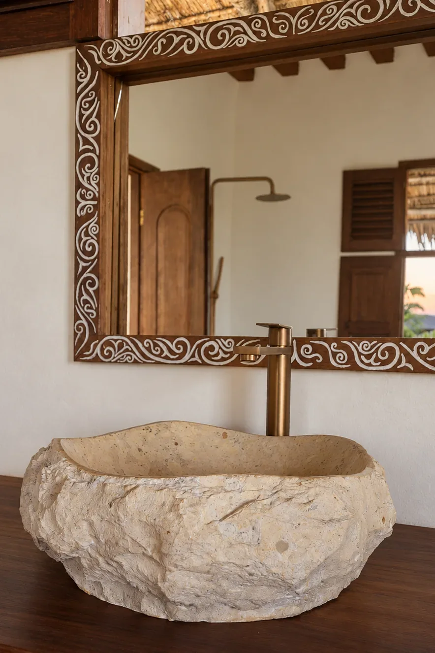 Mālama first-floor ensuite, rough-hewn stone basin and a carved mirror