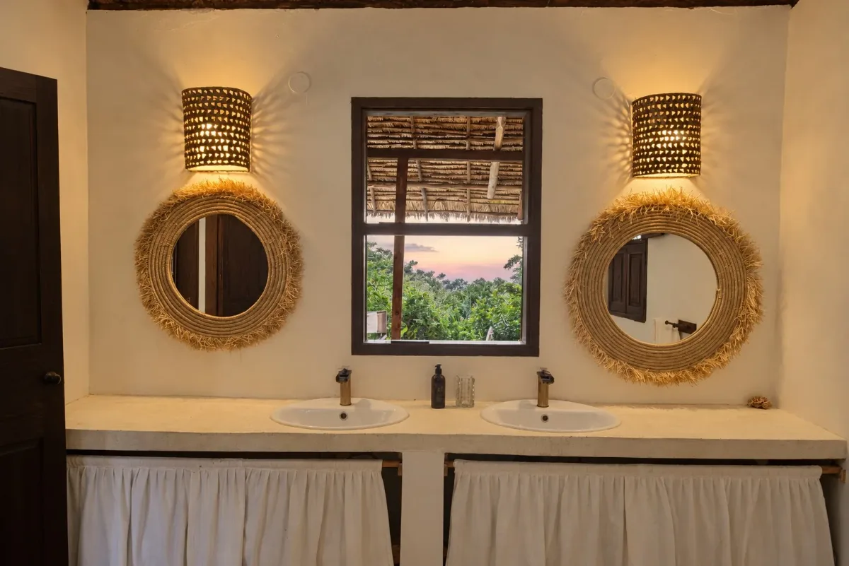 ʻOhana cabana, double vanity with woven mirrors and a sunset window